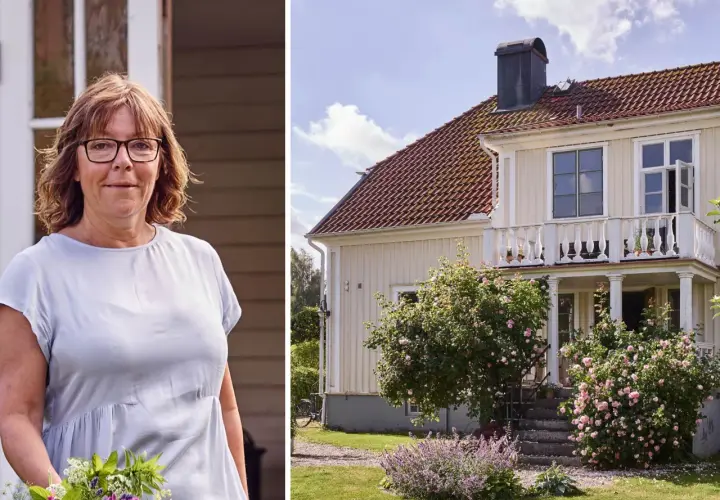 Kvinna med blommor framför ett charmigt 30-tals hus med en vacker rosenbuske.