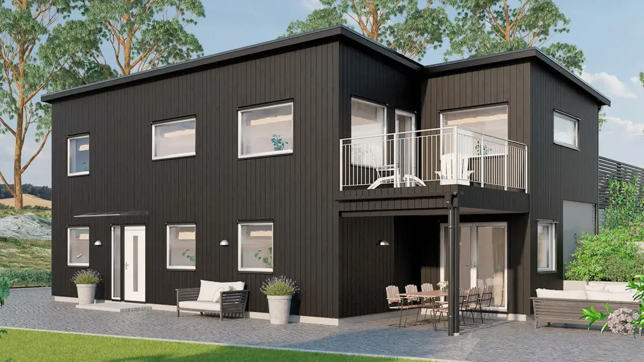 Modernt svart hus med balkong och uteplats. En vacker svart husgrund som sm&auml;lter in i naturen.